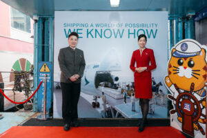 Uniformed airline crew posing by airplane poster