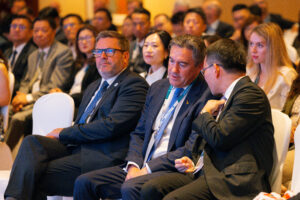 Attendees conversing during conference session