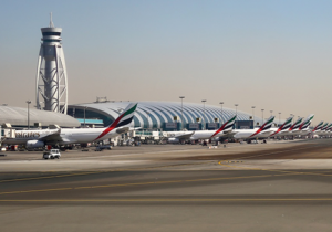 Row of Emirates jets at Dubai airport terminal