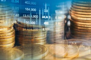 Stacks of coins with stock market chart